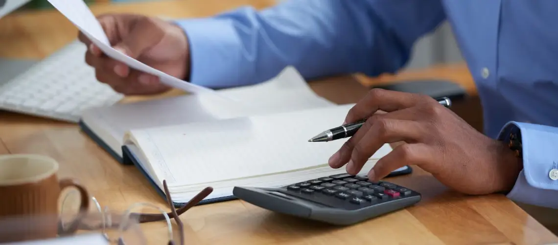 Professional analysing financial statements for business valuation Brisbane in office